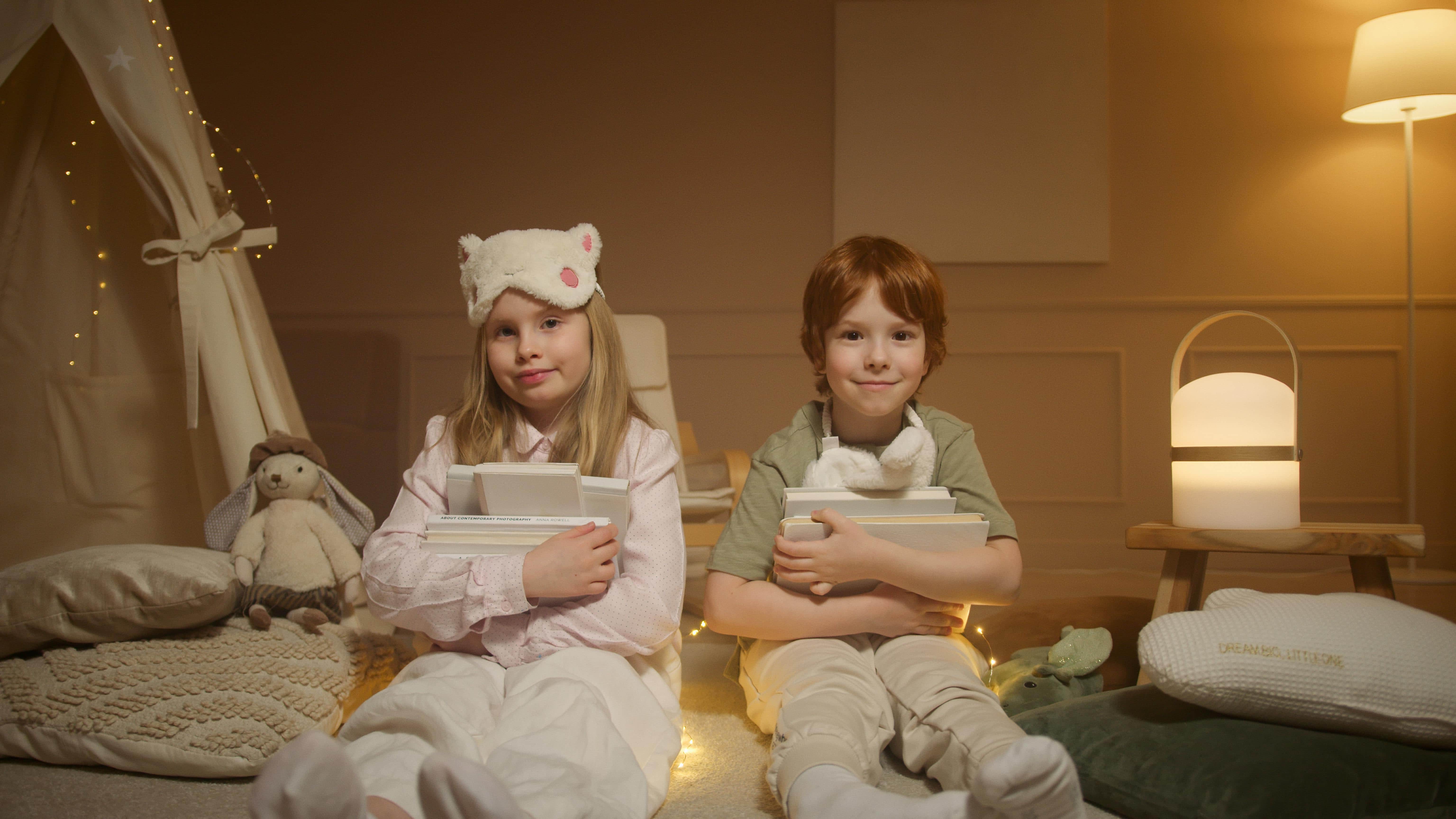 Children reading books together at home